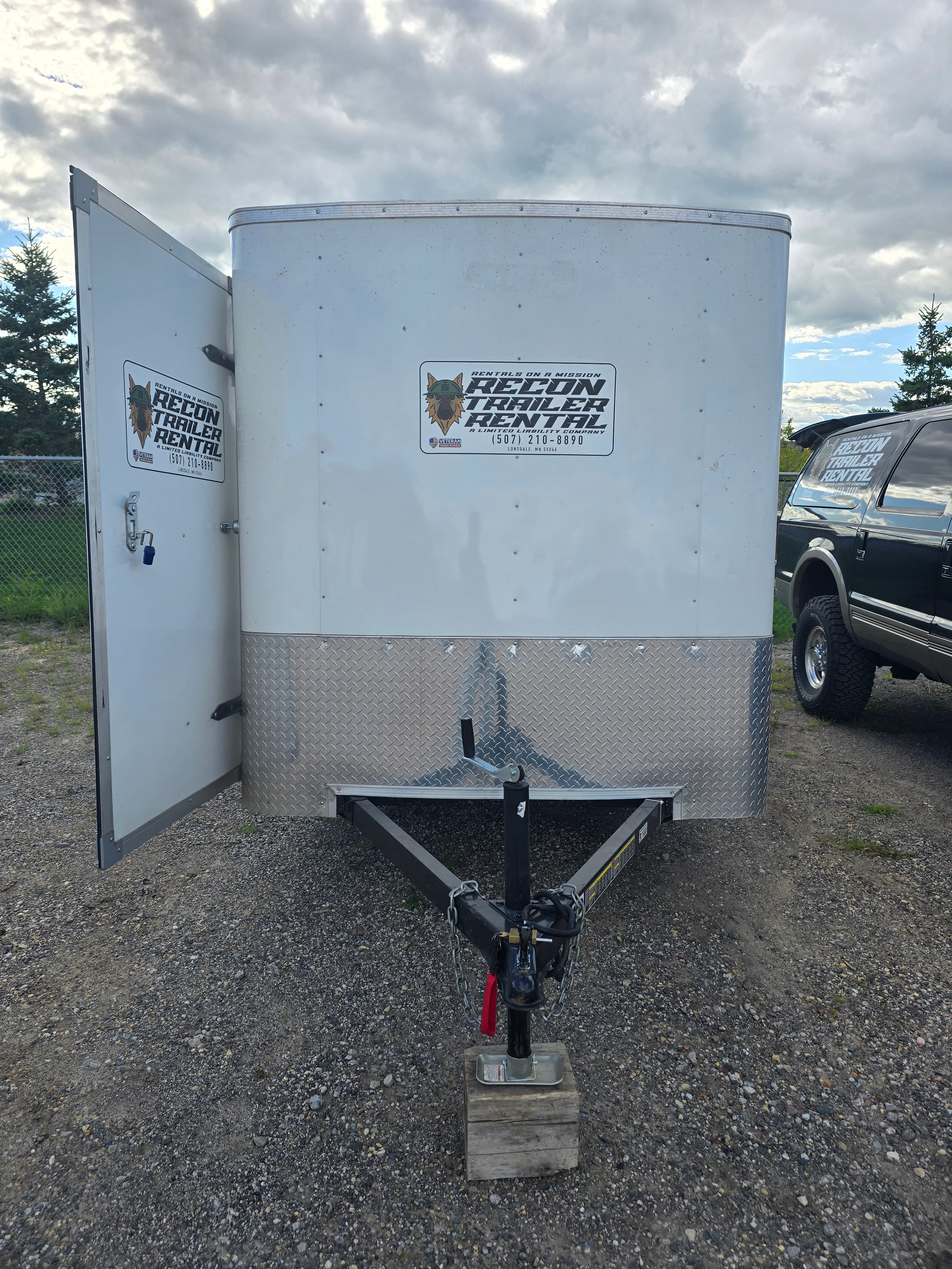 Enclosed trailer front view with diamond plate trim and secure hitch