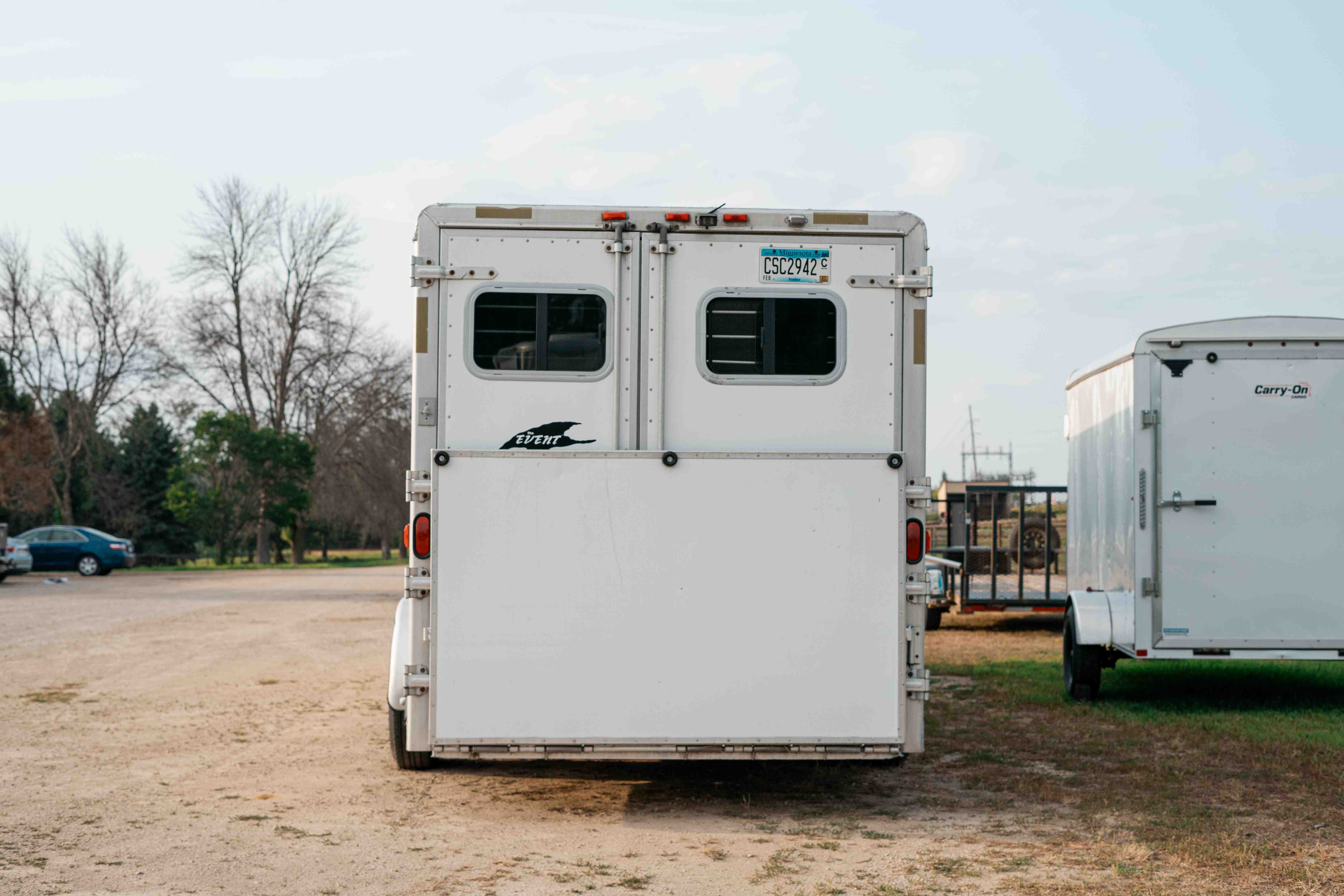 Exiss SS600 horse trailer rear view showing double doors, windows, and license plate