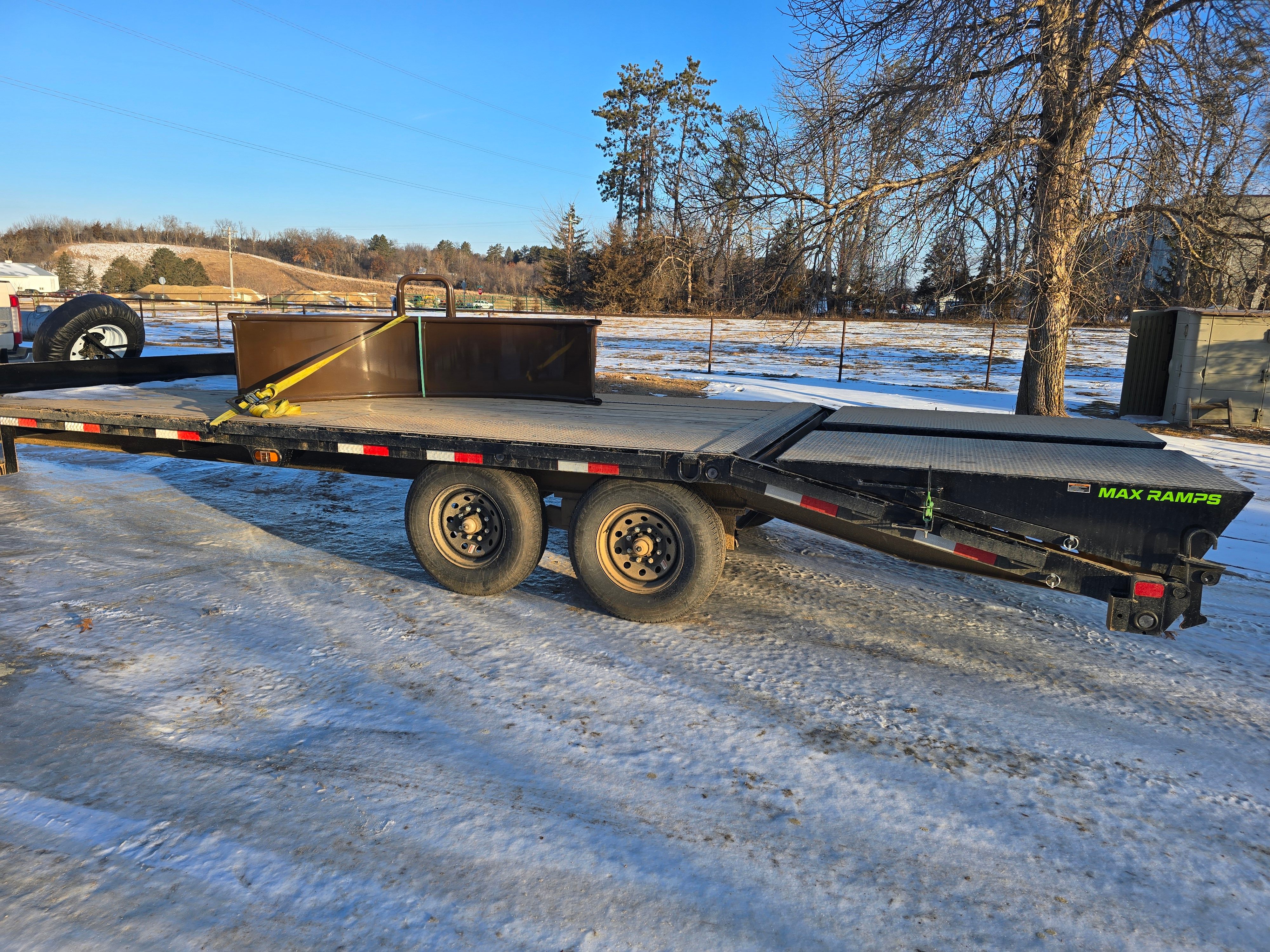 Load Trail deckover trailer side view in winter showing MAX RAMPS dovetail and dual axles